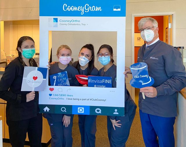 invisalign specialists holding sign in albany ny